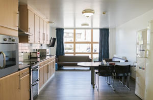 inside a communal kitchen with a view of the window