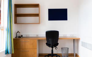table and chair against the wall in en-suite extra accommodation
