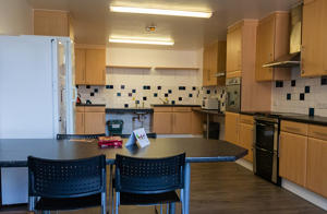 inside a communal kitchen with a view of a table