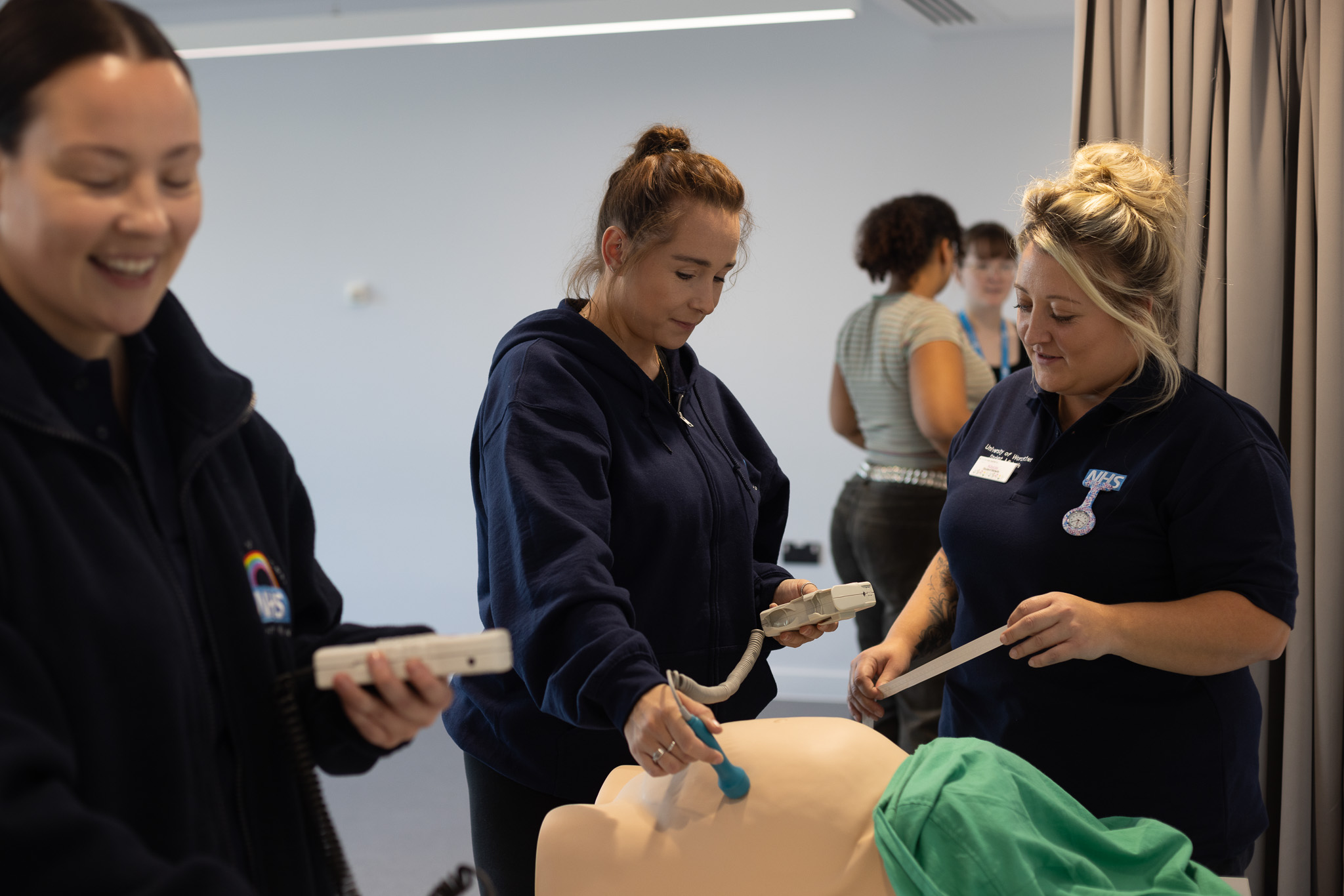 Midwifery student examining pregnant dummy