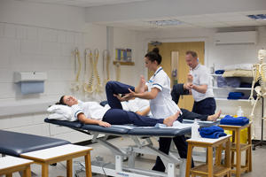 students administering physiotherapy to others who are lying down