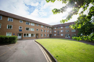 image of a road leading towards red-bricked student accommodation