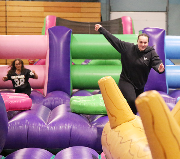 Students on an inflatable obstacle course