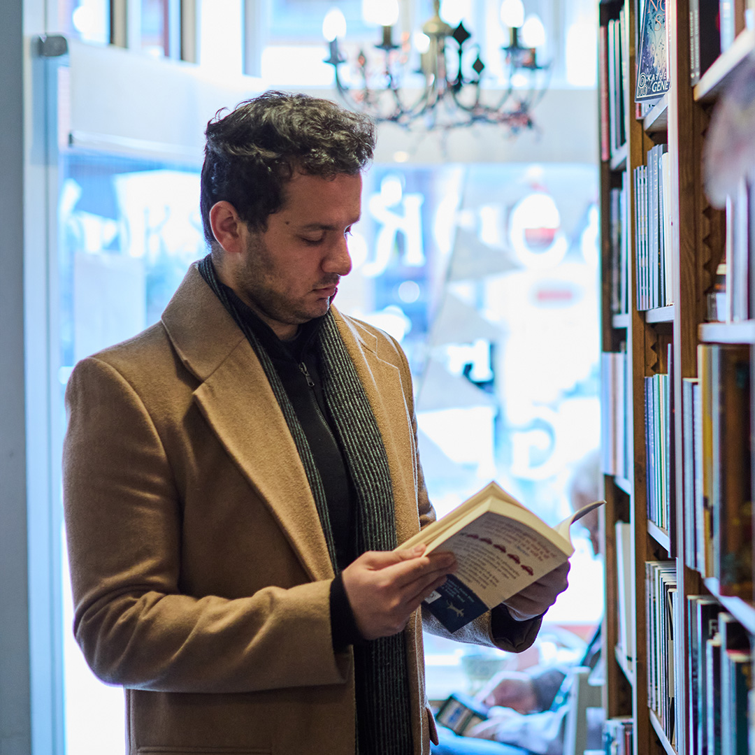 A student reading a book at a local bookshop