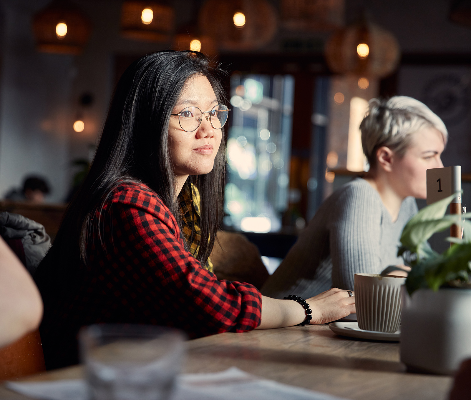 A student is sitting in a coffee shop