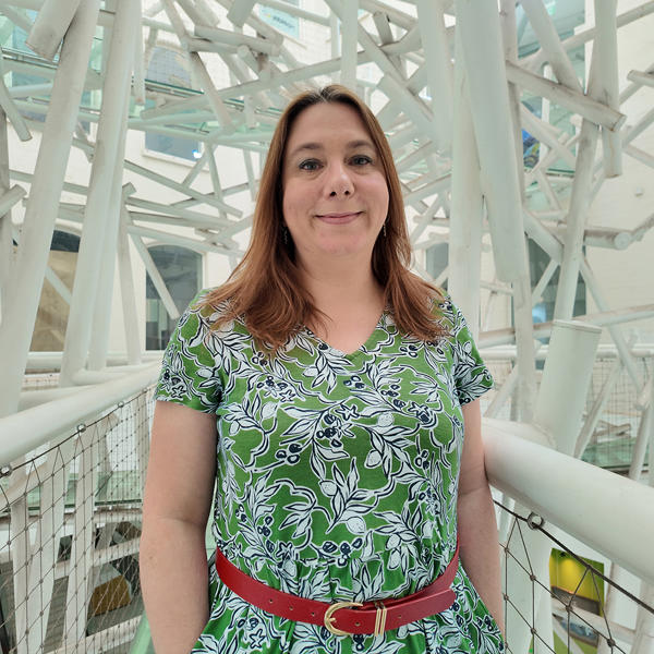 Person facing camera with white structures in background