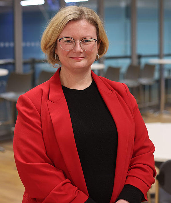 Maggie Tildesley wearing a red blazer looking at the camera