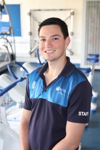 Dr John Francis dressed in sports attire smiling at camera