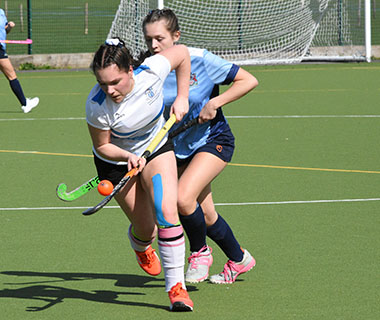 women playing hockey