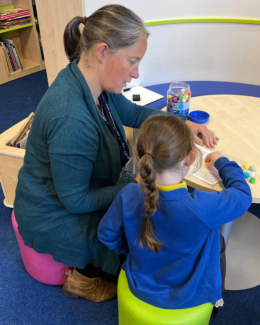 a teacher working with a student