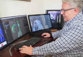 Graeme Gordon at work on a computer