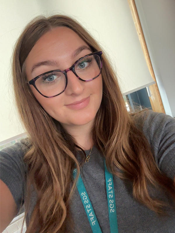 A woman wearing a school lanyard