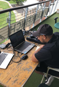 A man is analysing a cricket game on a computer