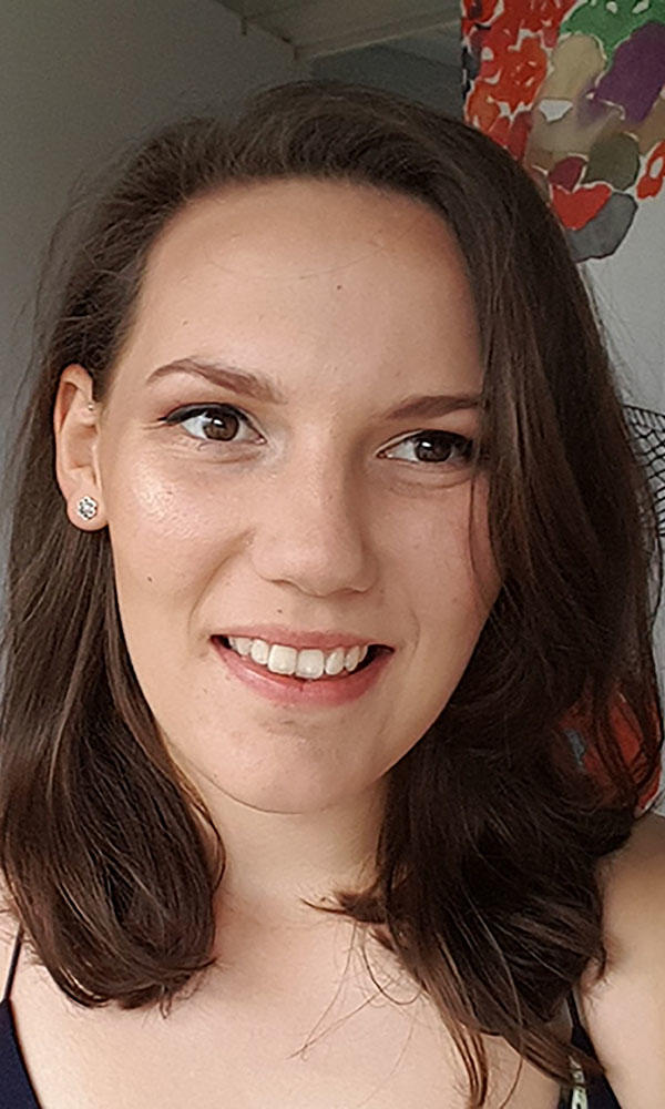 A woman with brown hair smiling