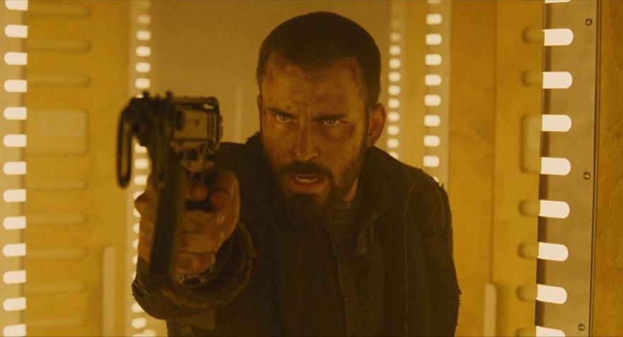 A still from the film Snowpiercer of a man aiming a gun at the camera