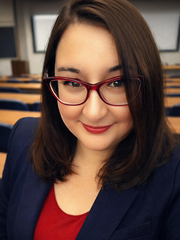 A woman smiling in a lecture theatre