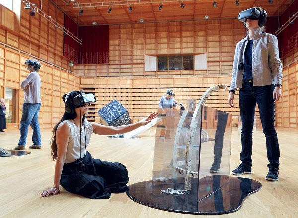 Several people are wearing virtual reality helmets