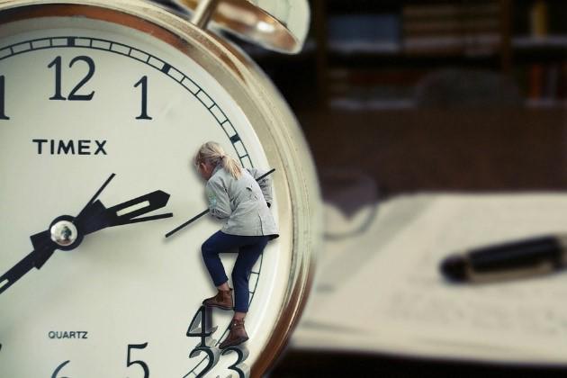 A woman trying to save time by climbing a clockface