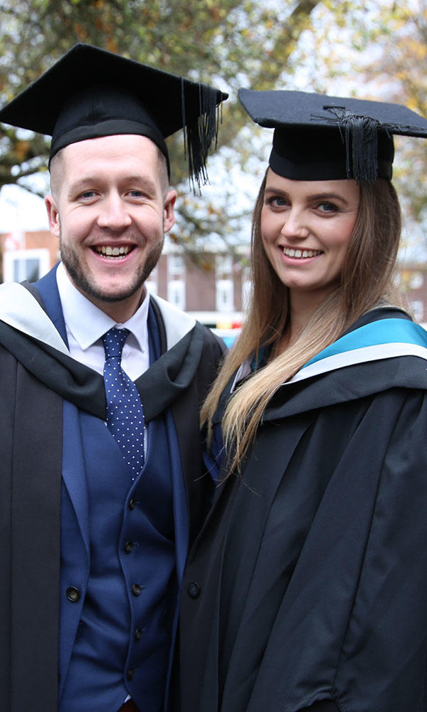Dan and Kate Archer wearing graduation robes