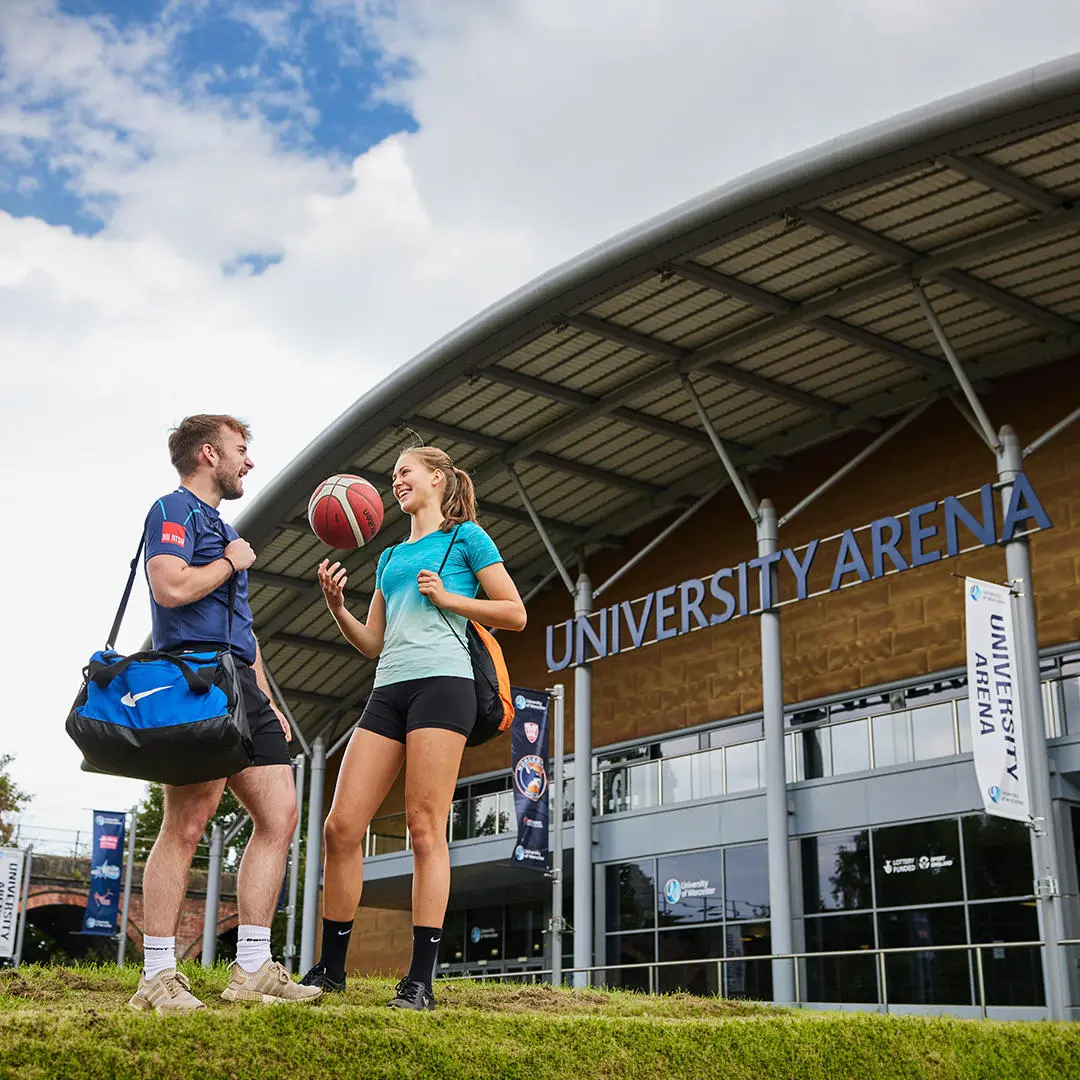 two sport students outside an arena