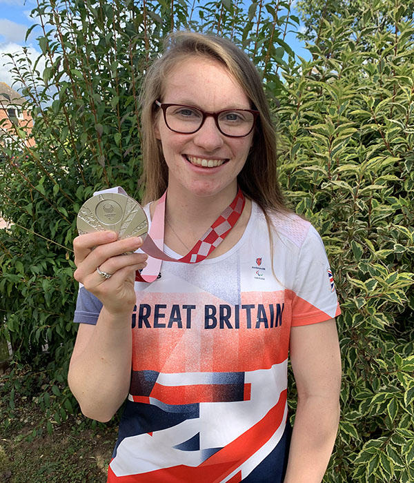 Becky Redfern in Great Britain attire holding a medal