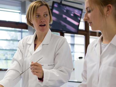 Students in white lab coats