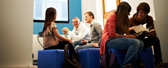 A group of students talking and reading books