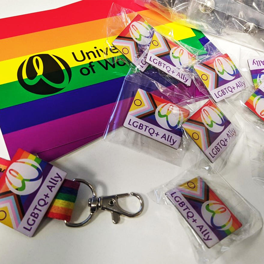 Rainbow postcard, inclusivity flag pin badges and a rainbow lanyard