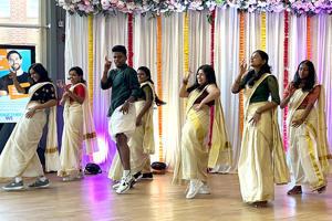 A group of students are dancing at Onam