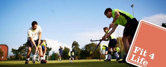 A group of men are playing hockey and wearing brightly coloured sports clothing