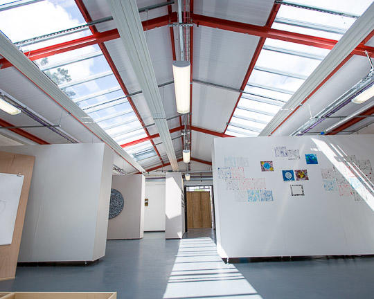 A shot of the inside of the Garage Art Studio. The room is white and spacious.