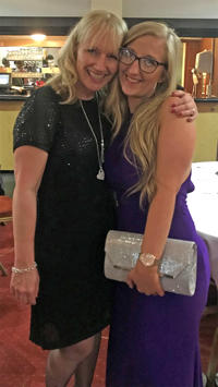 Primary Initial Teacher Education (with QTS) graduate Sophie Bowen is wearing a purple formal dress. She is hugging another woman who is dressed in black formal attire.
