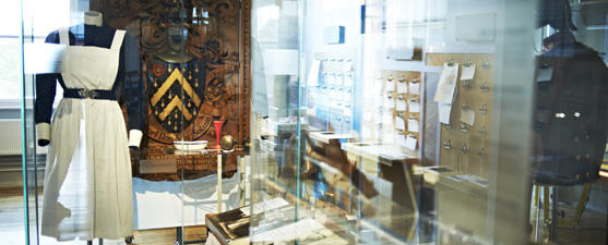 A shot of the museum cases in the Infirmary building, including an old nurses outfit, equipment and men's jacket.