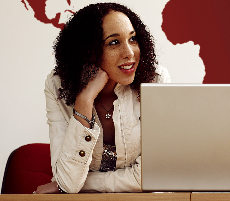 Student sitting behind a laptop