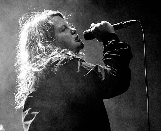 The poet Kate Tempest speaking into a microphone