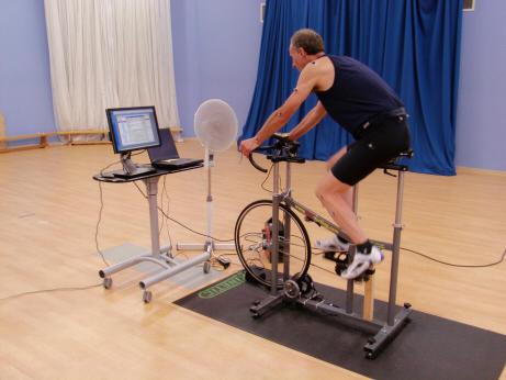 A man cycles on an indoor bicycle with Motion Performance Capture technology