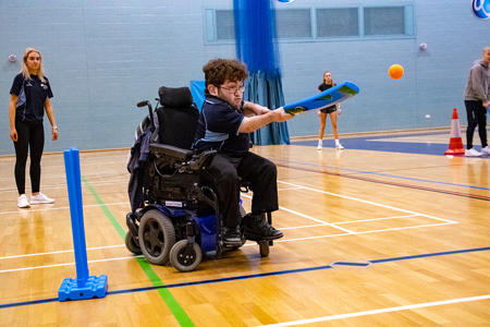 Man in wheelchair playing cricket