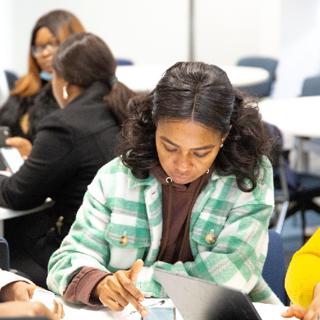 female student in a green and white top