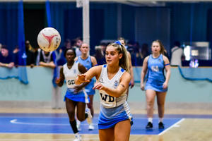 University of Worcester netball player catching a netball in a game