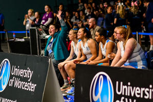 University of Worcester netball players and coach cheering on their team