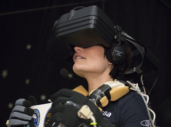 A woman plays a game with a VR headset on
