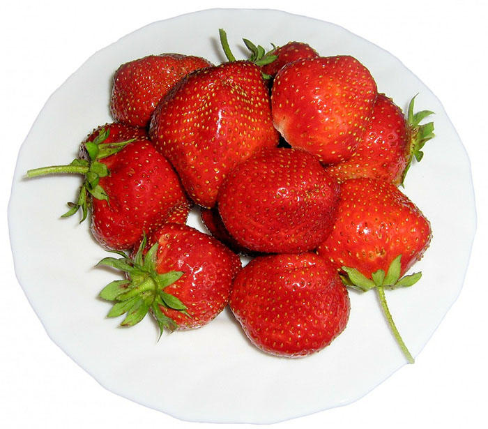 A close up picture of a bowl of strawberries