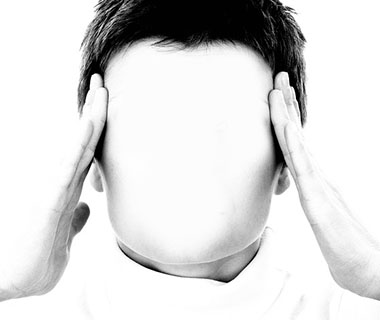 A faceless person is holding their head to indicate that they are stressed.