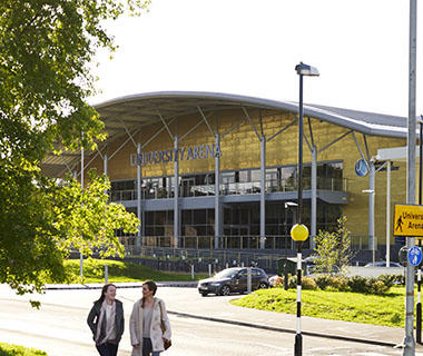 Two students walk past University of Worcester Arena