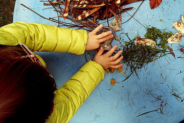 overhead photo of a child in a yellow jacket