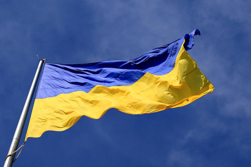Ukrainian flag flying against a blue sky