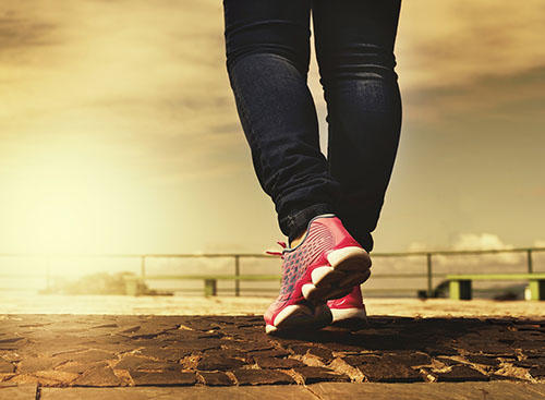 Feet clad in pink trainers are walking along