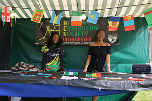 Two students are standing at the Afro Caribbean society stall at the Welcome fair