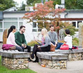 a group of students are talking animatedly