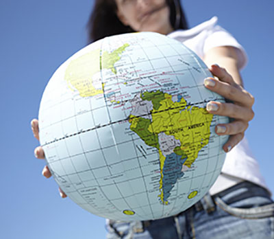 A person is holding a globe